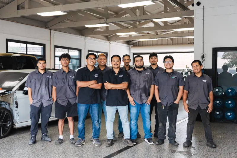 The full 417 Autoworks team lined up inside the shop